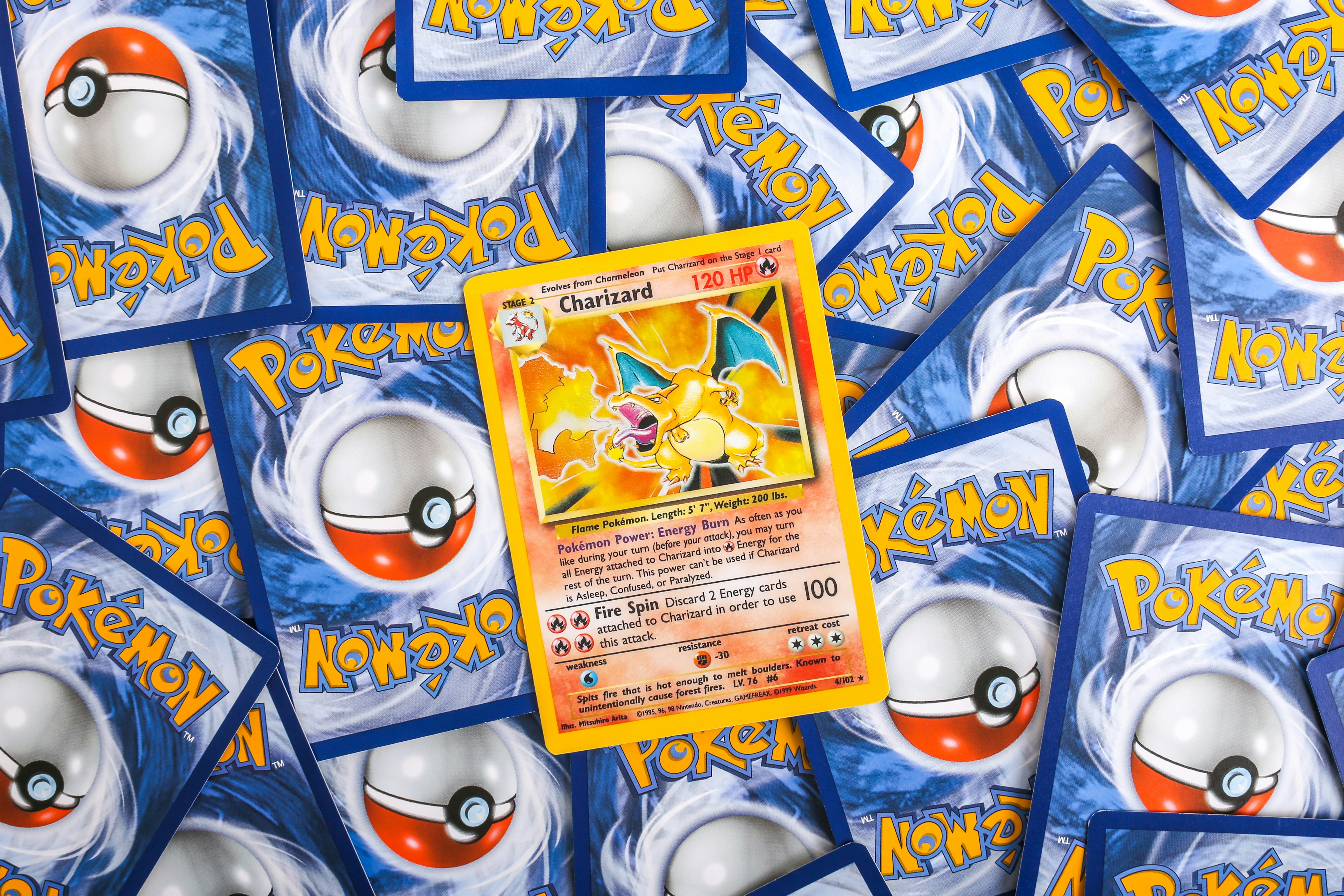 Rare holographic Pokémon trading cards including Charizard and Pikachu